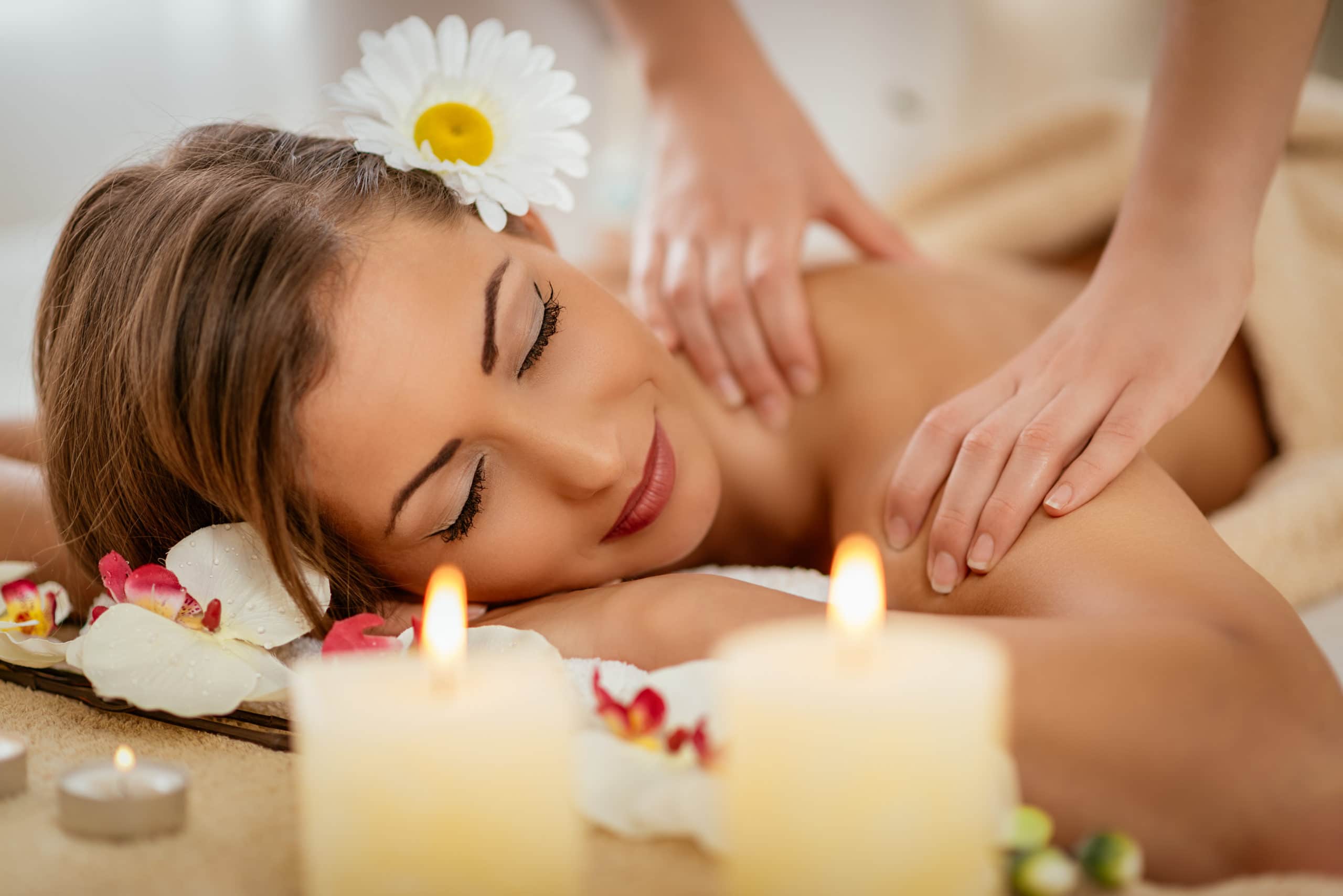 Beautiful woman enjoying during a shoulder massage at a spa.