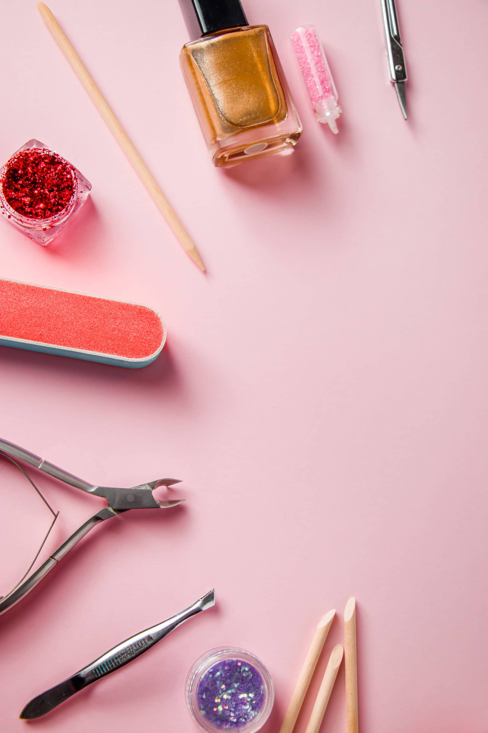 A set of tools for manicure and nail care on a pink background. Workplace in a beauty salon. Place for text.